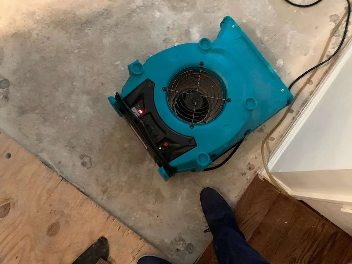 Air mover drying subfloor during Commercial Water Damage Restoration in Adairsville
